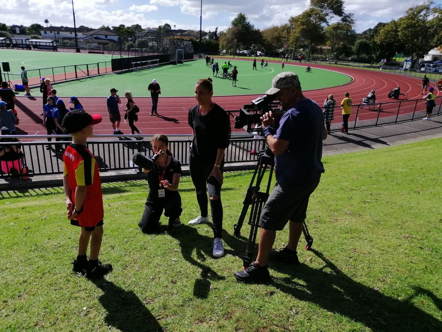 Zac Schultz being interviewed by a Sky Sport television crew beside the track at the Halberg Games